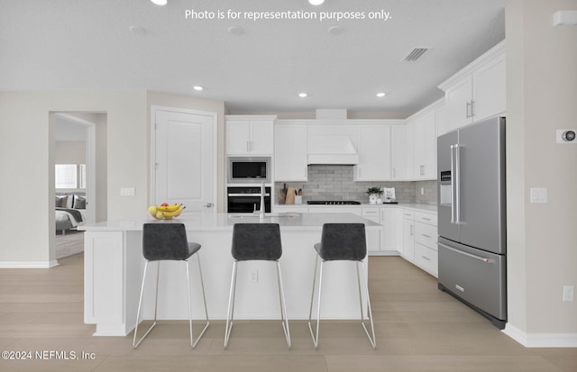 kitchen with decorative backsplash, appliances with stainless steel finishes, sink, and white cabinets