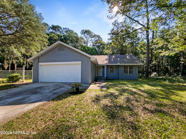 ranch-style house with a garage and a front yard