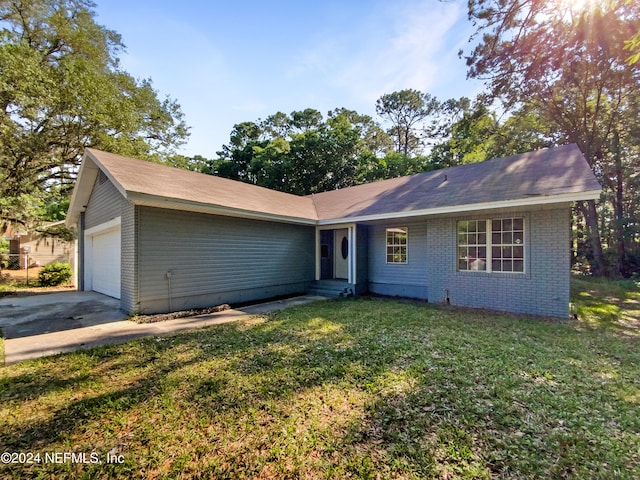 single story home featuring a front lawn and a garage