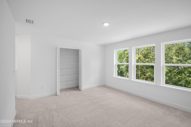 empty room featuring light carpet