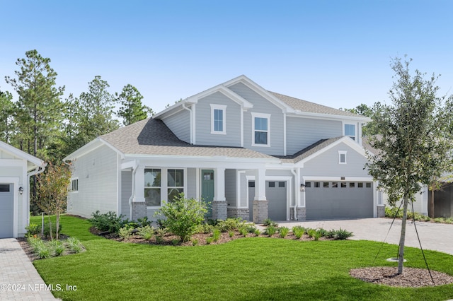 view of front of property with a garage and a front lawn