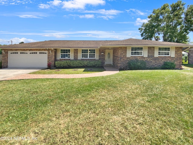 single story home featuring a front lawn and a garage