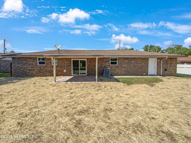 back of property with a patio, a lawn, and central air condition unit