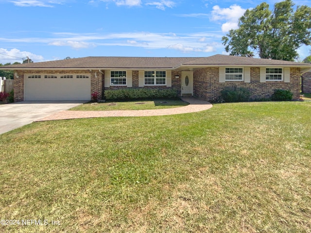 single story home with a garage and a front lawn