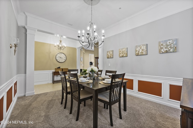 dining space with carpet, crown molding, and decorative columns