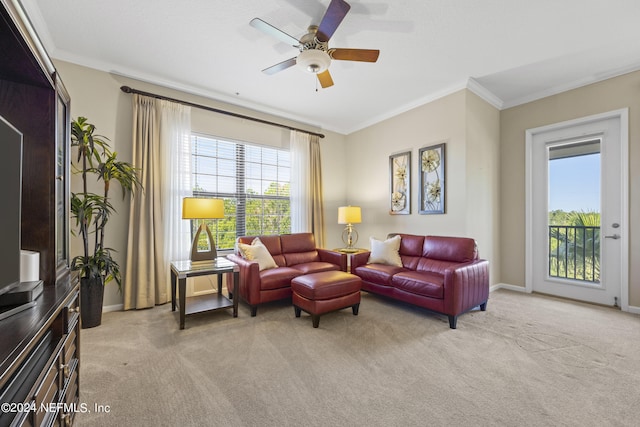 living room with ornamental molding, light colored carpet, and ceiling fan