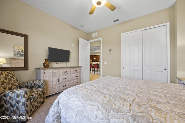 carpeted bedroom with a closet and ceiling fan