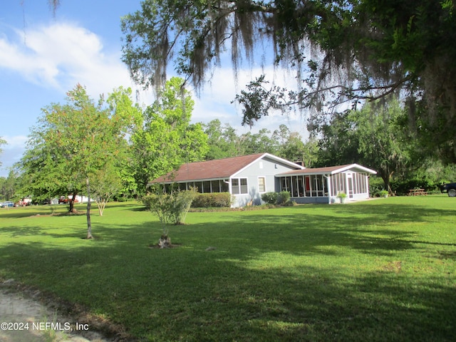 view of yard with a sunroom