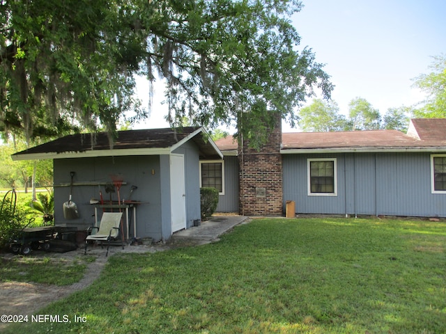 rear view of house with a lawn