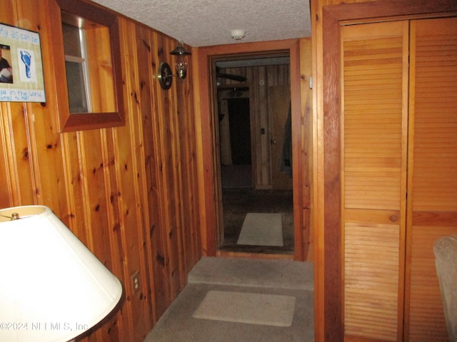 hall featuring a textured ceiling