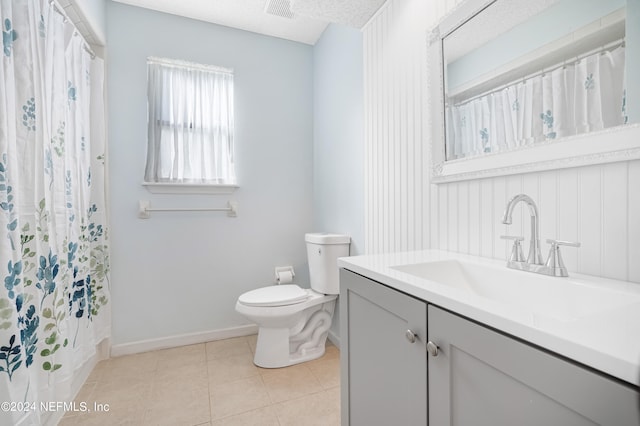 bathroom featuring a textured ceiling, toilet, vanity, a shower with curtain, and tile patterned flooring