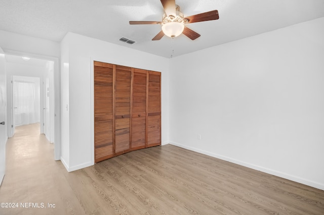 unfurnished bedroom with a closet, ceiling fan, and light hardwood / wood-style flooring