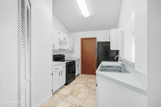 kitchen with lofted ceiling, white cabinets, black appliances, and sink