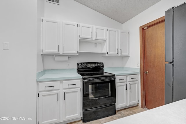 kitchen with black range with electric cooktop, vaulted ceiling, white cabinets, and stainless steel refrigerator