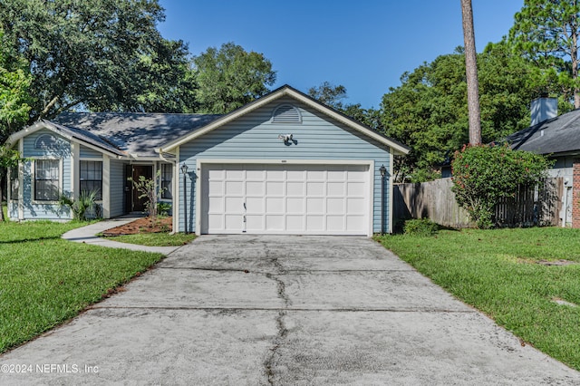 ranch-style home with a garage and a front lawn