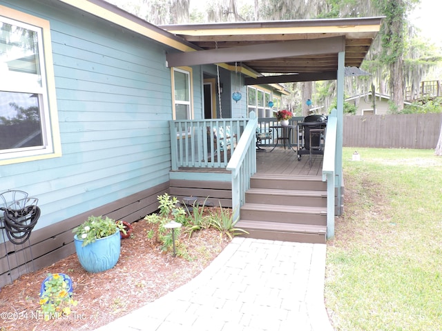 wooden terrace with a yard and area for grilling