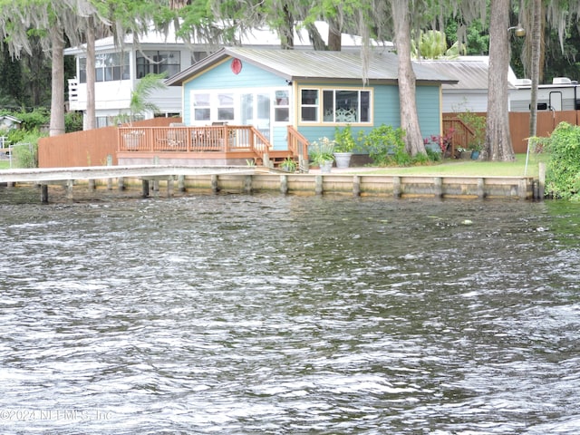 rear view of property featuring a water view