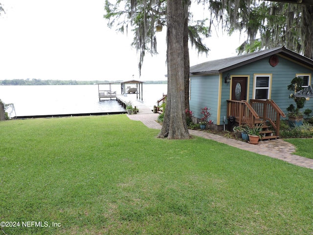 exterior space featuring a water view and a lawn