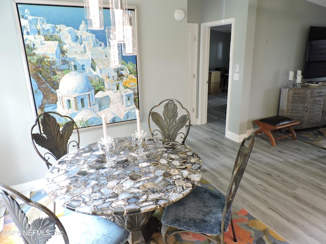 dining room with wood-type flooring