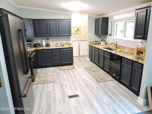 kitchen with independent washer and dryer, ornamental molding, appliances with stainless steel finishes, sink, and light hardwood / wood-style floors