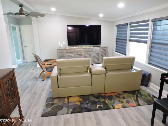 living room with crown molding, light hardwood / wood-style floors, and ceiling fan