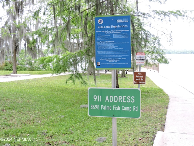 community / neighborhood sign with a lawn