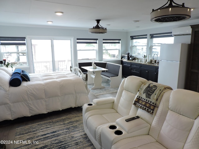 bedroom featuring an AC wall unit, white refrigerator, dark wood-type flooring, and multiple windows