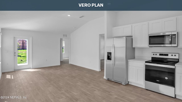 kitchen featuring high vaulted ceiling, appliances with stainless steel finishes, white cabinetry, and light hardwood / wood-style flooring