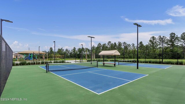 view of sport court featuring a playground