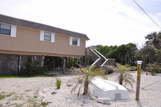 rear view of house featuring a carport