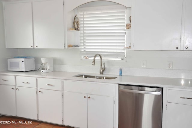 kitchen with dishwasher, sink, and white cabinets