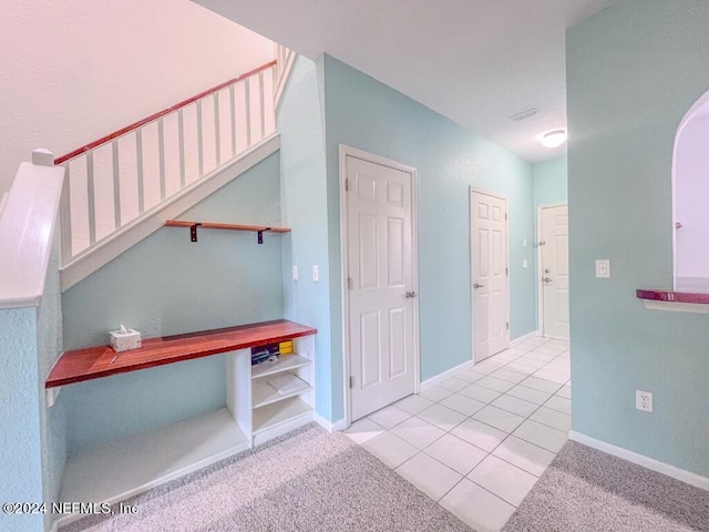 hall featuring light colored carpet