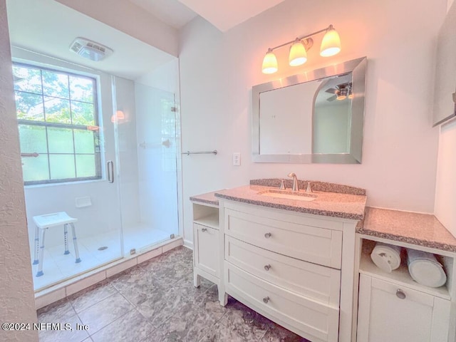 bathroom featuring walk in shower, tile patterned floors, and vanity