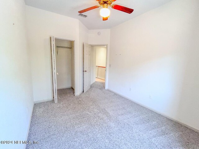 unfurnished bedroom featuring carpet and ceiling fan