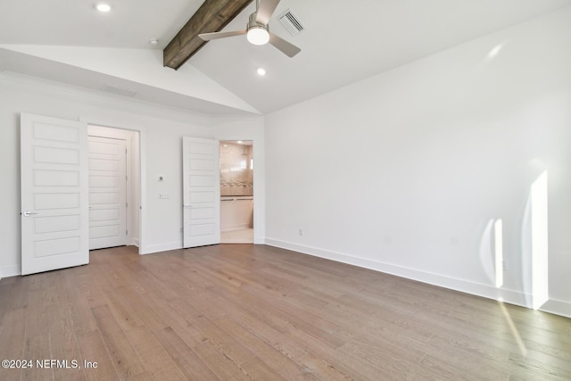 unfurnished bedroom with ensuite bath, ceiling fan, lofted ceiling with beams, a closet, and light wood-type flooring