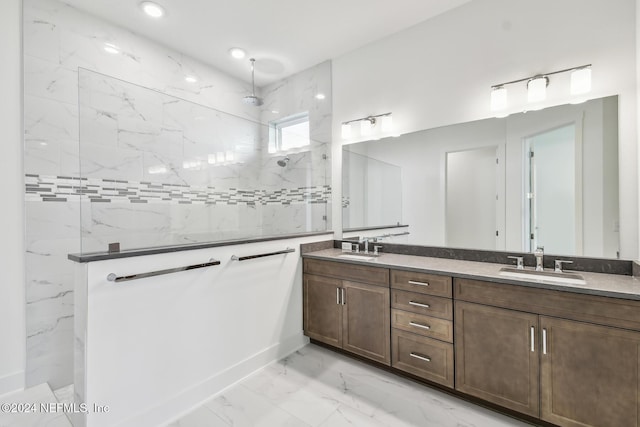 bathroom with vanity and tiled shower