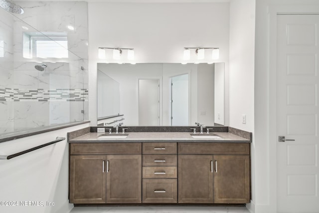 bathroom featuring a tile shower and vanity