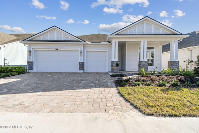 view of front of house featuring a porch and a garage