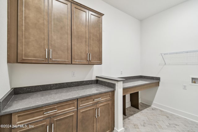 washroom with hookup for a washing machine and cabinets