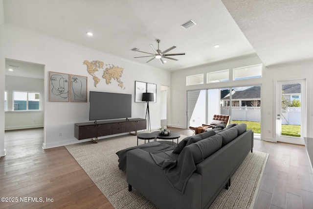 living room featuring hardwood / wood-style floors, a wealth of natural light, and ceiling fan