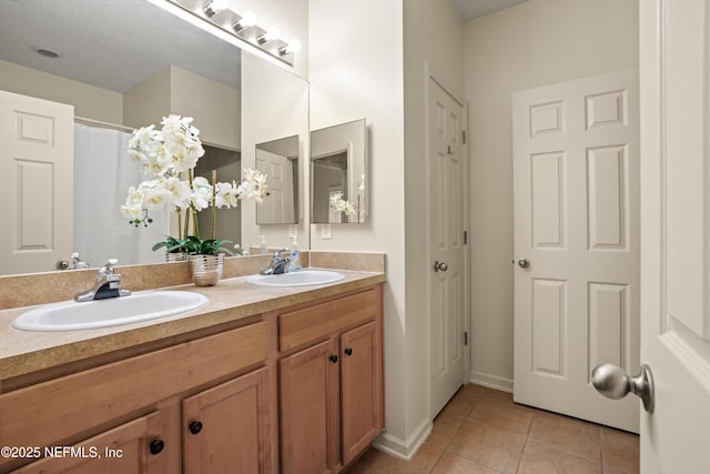 bathroom with tile patterned flooring and vanity