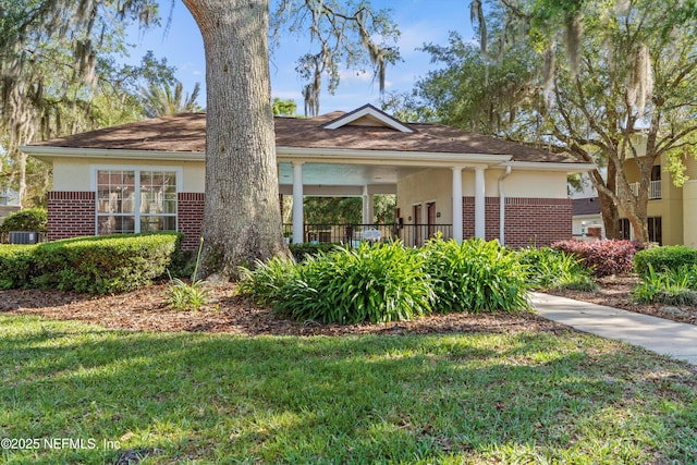 view of front facade with a front lawn and central air condition unit