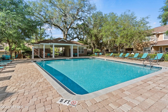 view of swimming pool featuring a patio area and an outbuilding