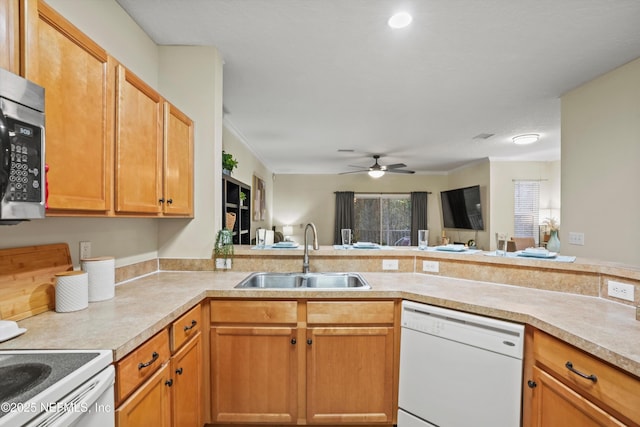 kitchen featuring sink, ceiling fan, kitchen peninsula, and white dishwasher