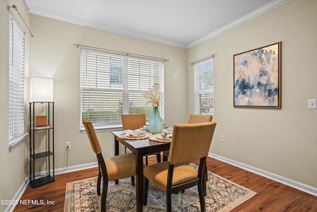 dining room featuring a wealth of natural light, dark hardwood / wood-style floors, and ornamental molding