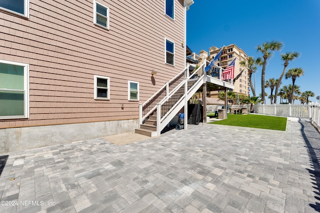 rear view of property featuring a patio and a yard