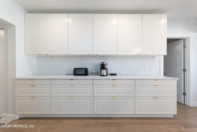 kitchen featuring light hardwood / wood-style flooring and white cabinetry