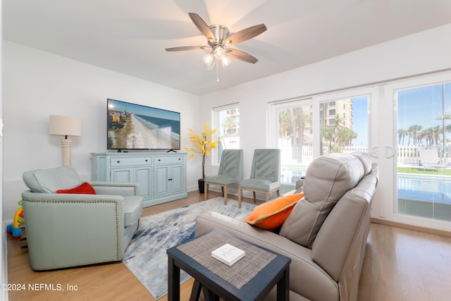 living room featuring ceiling fan and light wood-type flooring