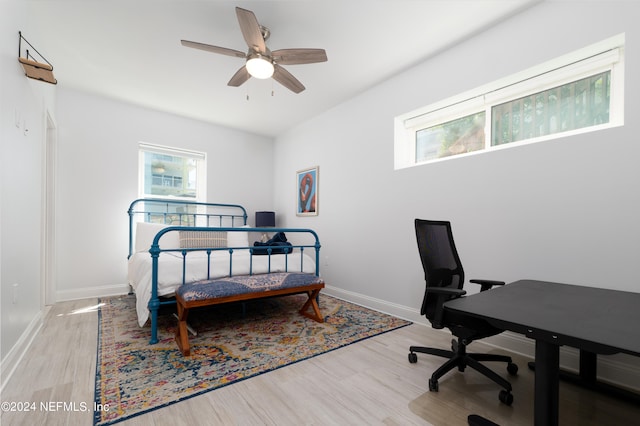 bedroom with light hardwood / wood-style flooring and ceiling fan