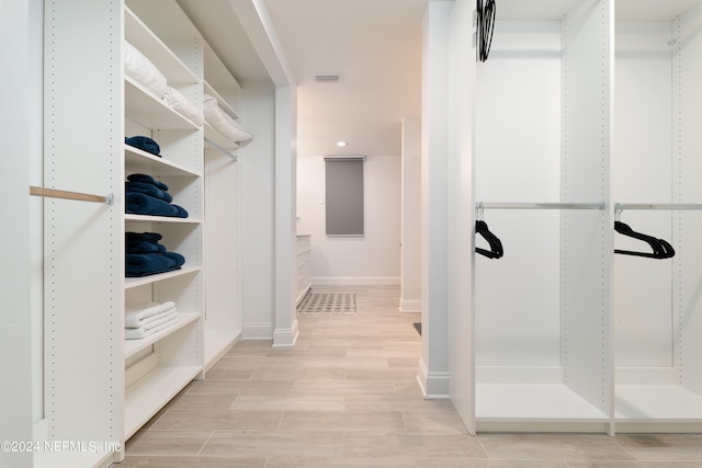 walk in closet featuring light hardwood / wood-style floors